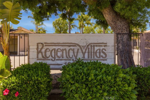 Front view of a house with a visible sign reading 'Regency Villas', surrounded by trees and bushes.