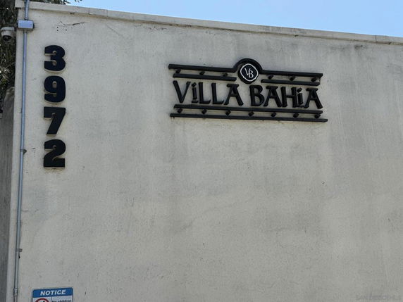 Exterior wall with address number and building name displayed.