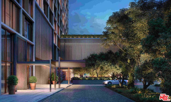 Front view of a modern multi-story building with an entrance canopy.