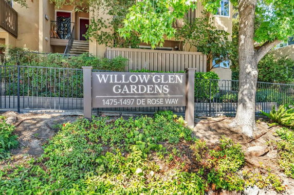 Front view of a building with signage Willow Glen Gardens at 1475-1497 De Rose Way.