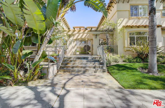 Front view of a two-story house with steps leading to the entrance.