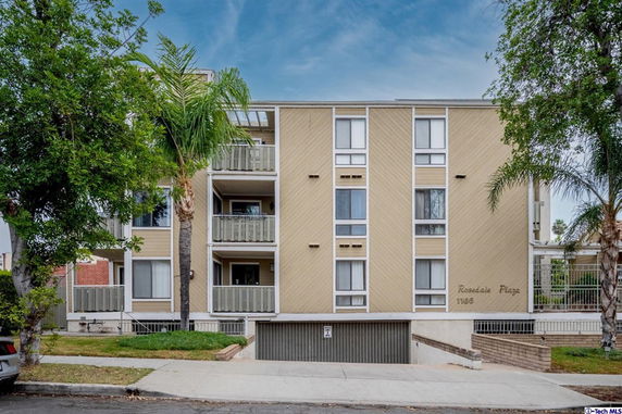 Front view of a multi-story residential building with balconies.