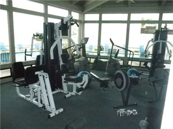 Indoor gym area with various exercise equipment.