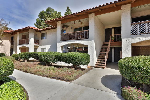 Front view of a two-story residential building with balconies.