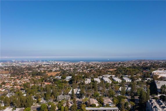 Panoramic view of a cityscape with distant ocean horizon.