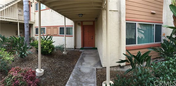 Front view of a building entrance with covered walkway.
