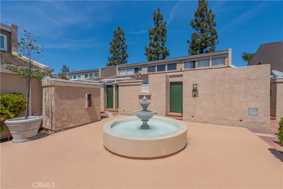 Front view of a building with minimalistic design and a central fountain.