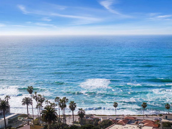 Wide-angle view of the ocean and coastline from a high vantage point.