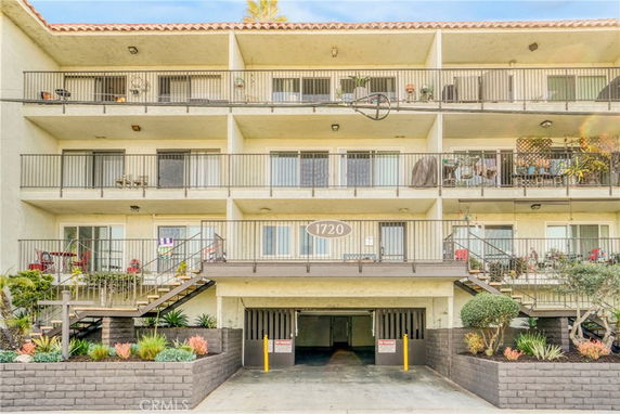 Front view of a multi-story apartment building with balconies.