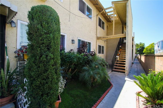 Exterior view of a two-story residential building with an external staircase.