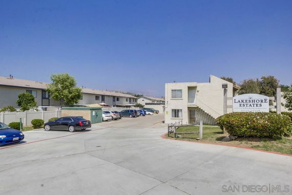 Front view of a two-story apartment building with parking area.