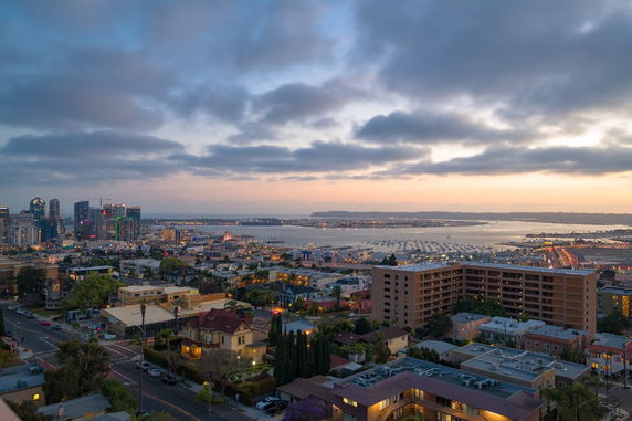 Panoramic view of a cityscape with buildings and a waterfront.