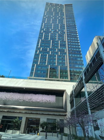 Front view of a modern high-rise building with glass facade.