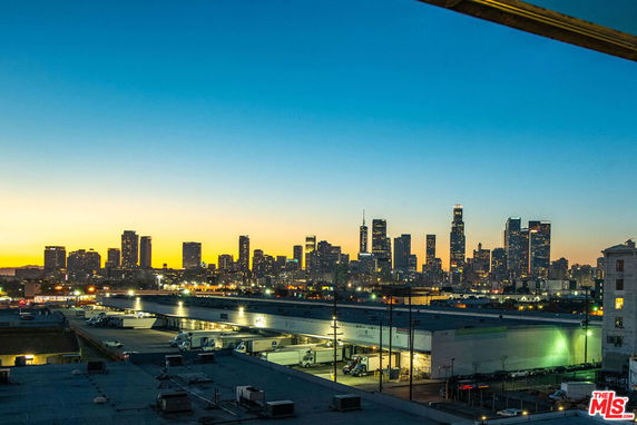 Panoramic view of a city skyline at sunset.