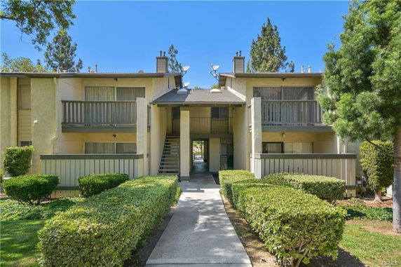 Front view of a two-story apartment building with balconies.