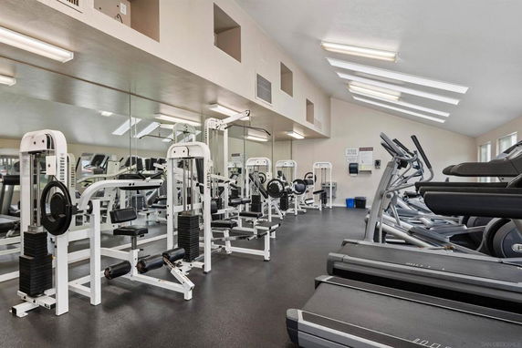 Interior of a gym with exercise machines and treadmills.