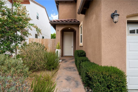 Front view of a house entrance with a pathway and garden.