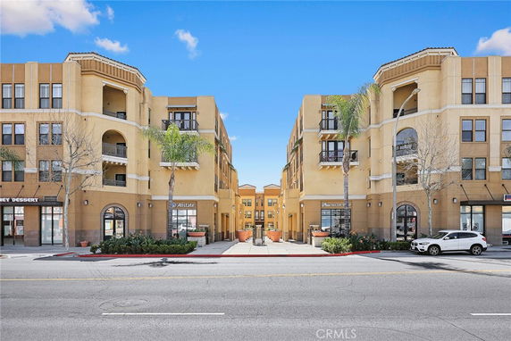Front view of a multi-story commercial and residential building.
