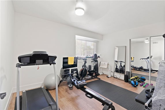 Indoor exercise room with a treadmill, stationary bike, and fitness equipment.