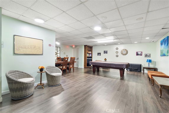Room with a pool table and seating area.