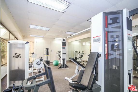 Indoor gym area with various fitness equipment.