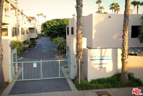 Front view of a townhouse complex with gated entrance.