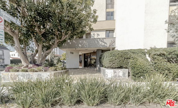 Front view of a multi-story building with a main entrance.