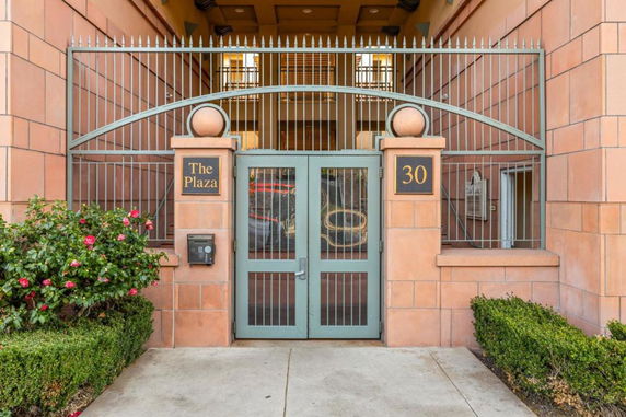 Front view of a building entrance with a gated entryway labeled 'The Plaza'.
