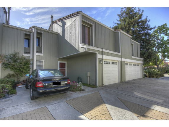 Front view of a modern two-story townhouse with an attached garage.