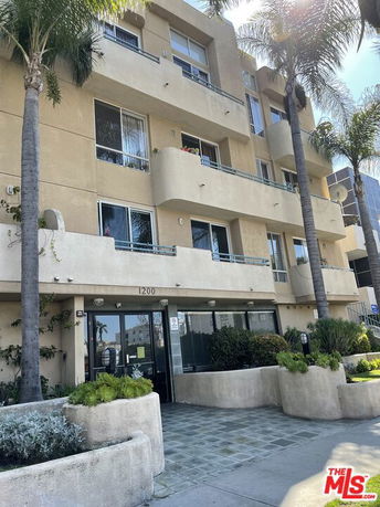 Front view of a multi-story residential building with balconies.