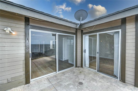 Rooftop area with sliding glass doors and a satellite dish.