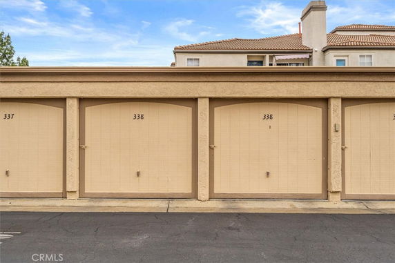 Outdoor parking area with numbered garage doors.