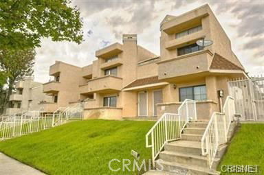 Front view of a multi-story residential building with modern architecture.