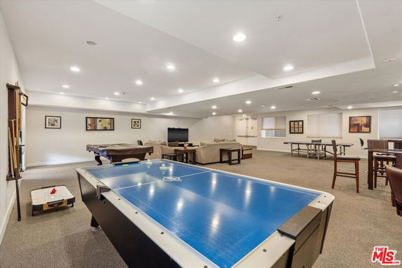 Indoor recreation room with tables and lounge area