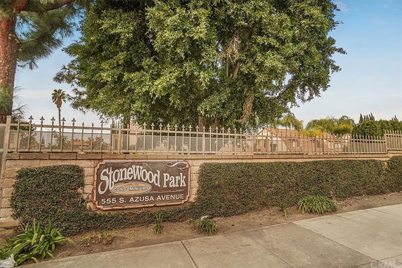 Front view of Stonewood Park Condominiums with a sign and entrance.