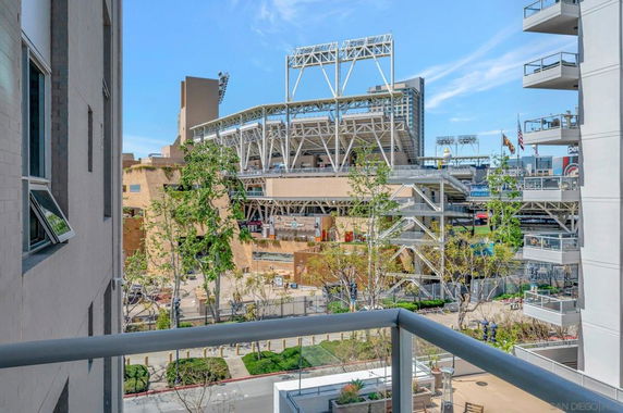 View of a stadium and surrounding structures seen from a building balcony.