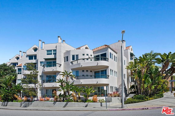Front view of a multi-story residential building with balconies.