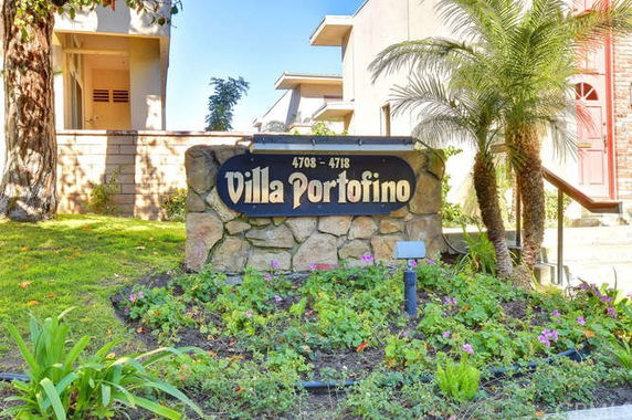 Front view of a building with a stone sign displaying 'Villa Portofino' and the numbers 4708-4718.