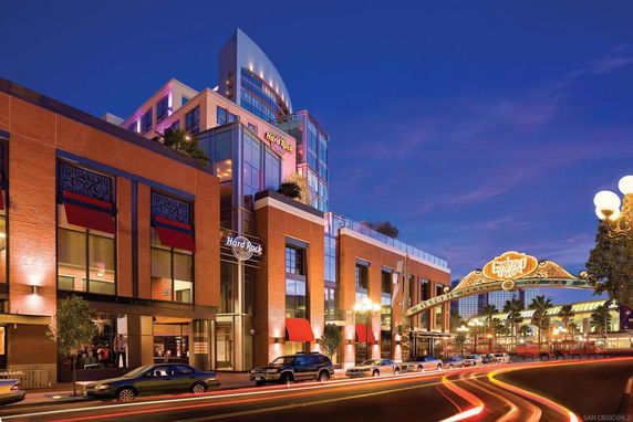 Front view of a multi-story building with a branded entrance and large glass windows.