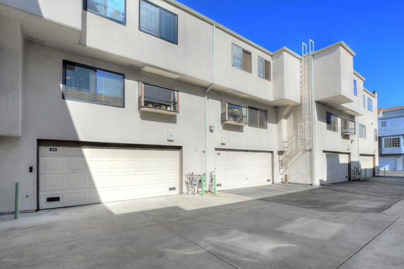 Front view of a multi-story building with garages.