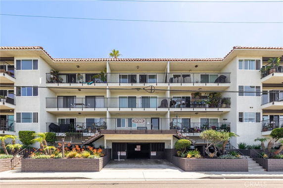 Front view of a multi-story residential building with balconies.