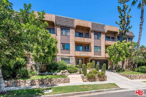 Front view of a multi-story residential building with balconies.
