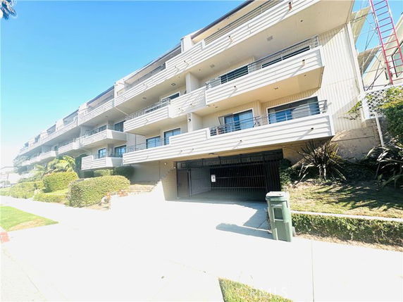 Front view of a multi-story building with balconies.