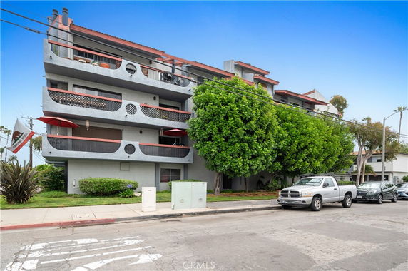Front view of a multi-story residential building with balconies.