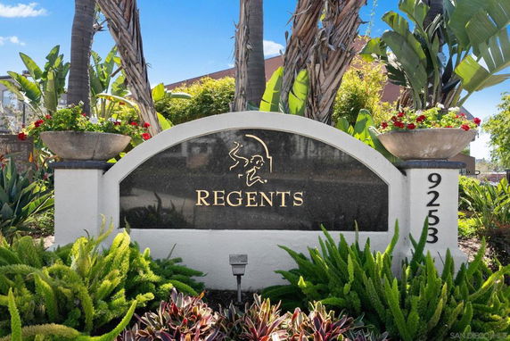 Front view of a building entrance sign with REGENTS inscribed on it.
