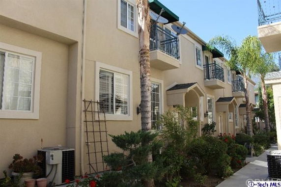 Front view of a multi-story apartment building with balconies.
