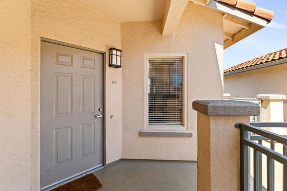 Front view of an entryway with a door and adjacent window.