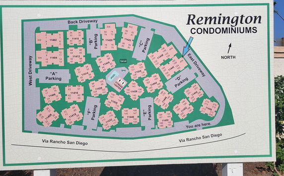 Outdoor directory map of Remington Condominiums showing building layout and parking areas.