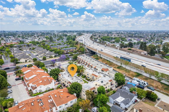 Aerial view of residential area with highways and surrounding cityscape.