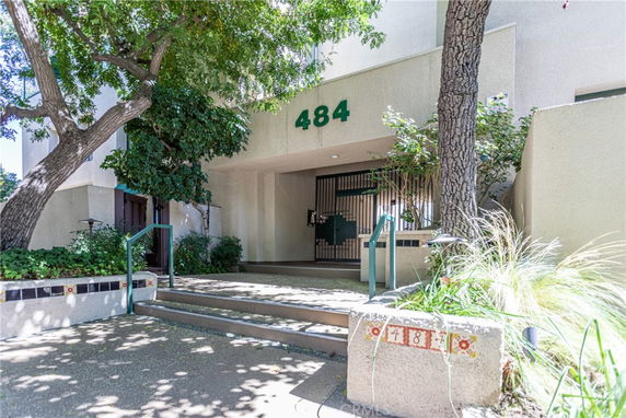 Front view of a building entrance with the number 484 above the doorway.